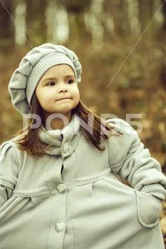 Little girl in autumn park Stock Photos