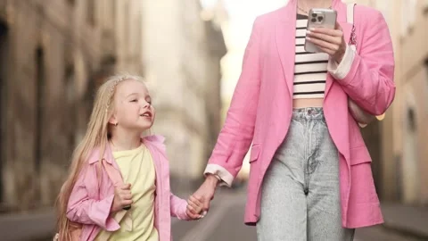 Little girl with backpack get back to home from school holding her mother's hand Stock Footage 242031795
