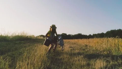 Little Girl with binoculars walking in open field Stock Footage