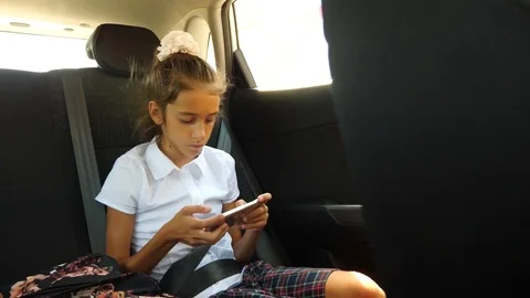 Little girl, bored in the car - looking out the window through the window - Stock Footage