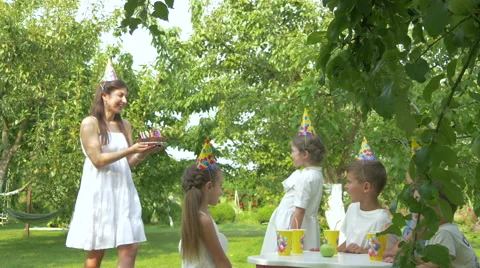 Little girl celebrating birthday in garden Stock Footage