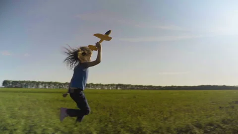 Little Girl Child In A Field With A Toy Plane At Sunset Stock Footage