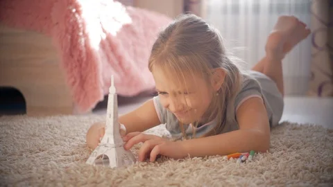Little girl at children room dreaming about vacation. Child dreaming about Stock Footage