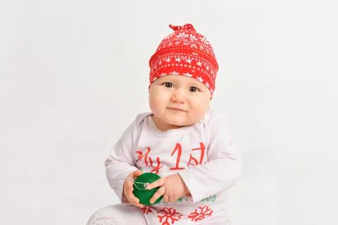 Little girl in christmas costume with new year tree ball Christmas baby Stock Photos