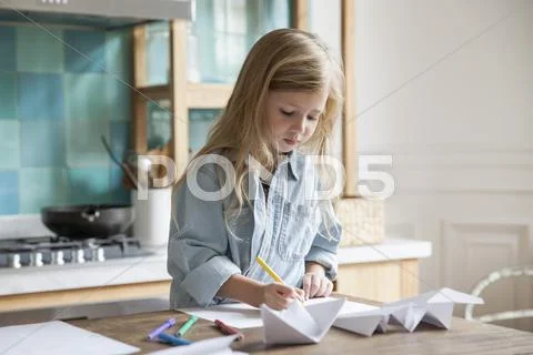Little Girl Coloring In Kitchen