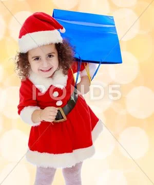 Little girl in costume of Santa Claus with colorful packages Stock Photos