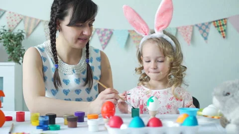 Little Girl Decorating Easter Eggs with Mother Stock-Footage 103893207