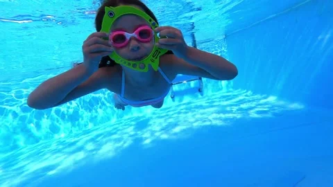 Little girl deftly swim with toy underwa... | Stock Video | Pond5