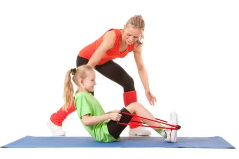 Little girl doing exercise with an instructor Stock Photos