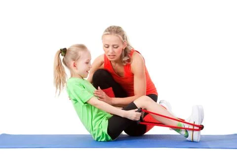 Little girl doing exercise with an instructor Stock Photos