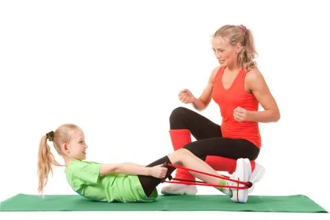Little girl doing exercise with an instructor Stock Photos