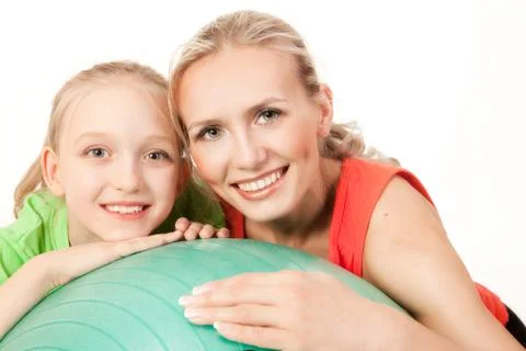 Little girl doing exercise with an instructor Stock Photos