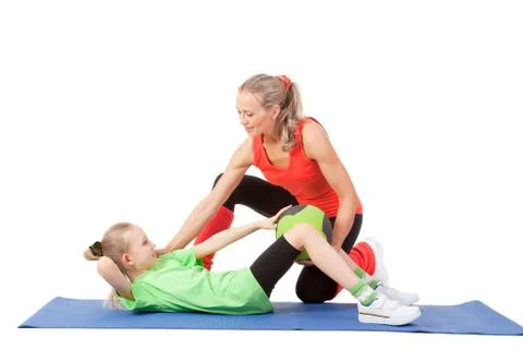 Little girl doing exercise with an instructor Stock Photos