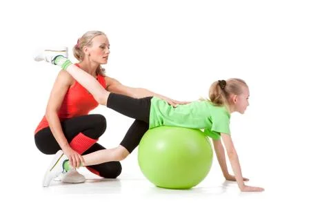 Little girl doing exercise with an instructor Stock Photos