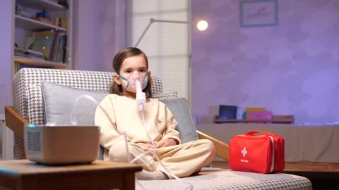 A little girl is doing nebulizer, inhale... | Stock Video | Pond5