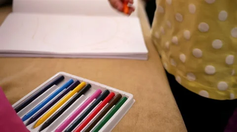 Little girl drawing with colored pencils Stock Footage