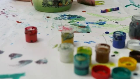 The little girl draws with her brother at the table in the house Stock Footage