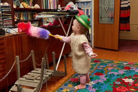 The little girl dusts Stock Photos