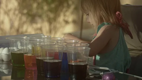 Little Girl Dyeing Easter Eggs Stock Footage 79736685