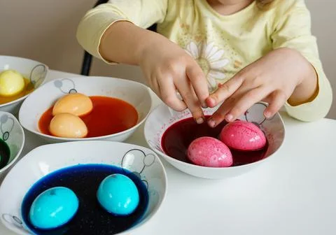 Little Girl Dyeing Easter Eggs Stock Photos