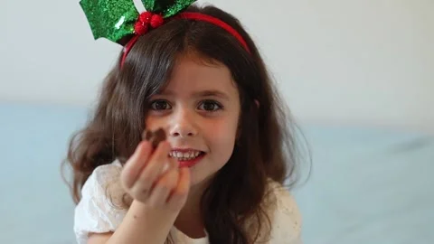 Little girl eats candy from the advent calendar. Stock Footage 221878895