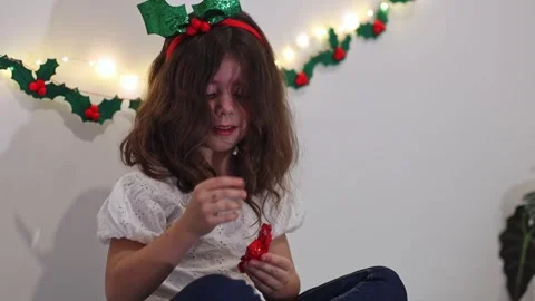 Little girl eats candy from the advent calendar. Stock Footage 253513330