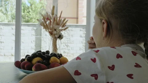 Little girl eats fruit Stock Footage 199276279