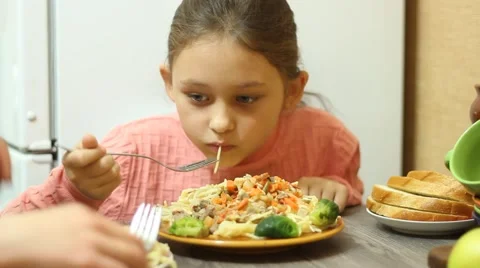 Little girl eats pasta Stock Footage 44643191