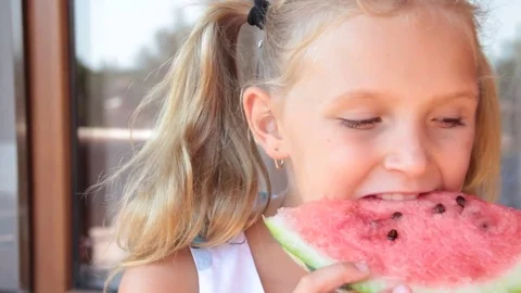 Little girl eats watermelon Stock Footage 80284720