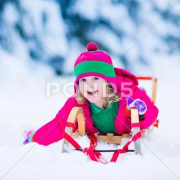 Little girl enjoying a sleigh ride in winter Stock Photos