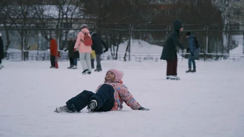 Little Girl Falling on Ice while Skating Stock Footage 145709114