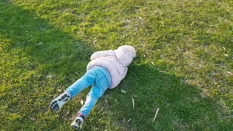 little girl falls while running on grass... | Stock Video | Pond5