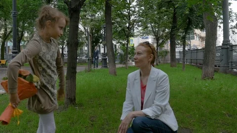 A little girl gives her mother a bouquet of flowers. Stock Footage