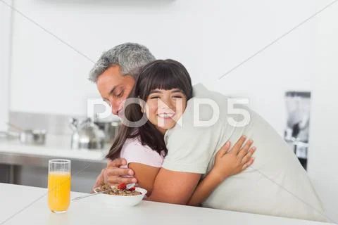 Little girl gives a hug to her father Stock Photos
