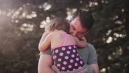 A Little Girl Giving Her Father A Huge Hug Outside Stock Footage