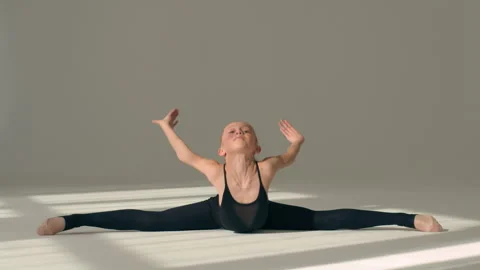 Little girl gymnast stretching aerobic on floor in dance studio ballet school Stock Footage 273986189