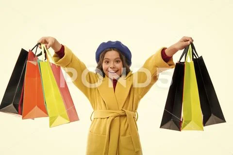 Little girl happy face hold bunch shopping bags. Shopaholic concept. Child Stock Photos