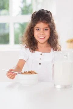 Little girl having cereal Stock Photos