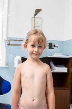Little girl is having systematic physical examination Stock Photos