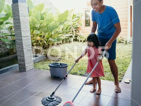 Little girl help her daddy to do chores Stock Photos