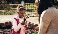 Little Girl Helping Her Mother In The Garden Stock Photos