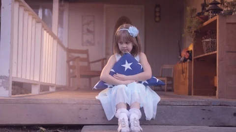Little Girl Hugging Folded American Flag | Cinematic Dolly 60P Stock Footage