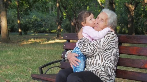 Little girl hugging grandmother. Stock Footage