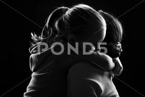 Little Girl Hugs Her Mother