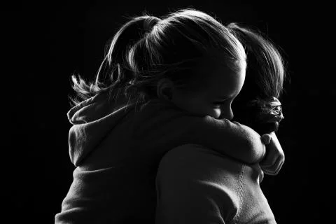 Little girl hugs her mother Stock Photos