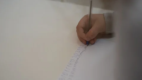 Little girl kid learn to write with numbers pen on a piece of paper Video stock 128317889