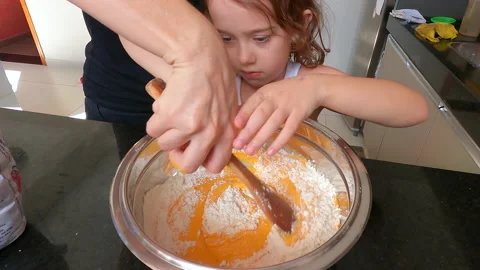 Little girl learning to make bread dough at home. Real people doing real things. Stock Footage 151612023