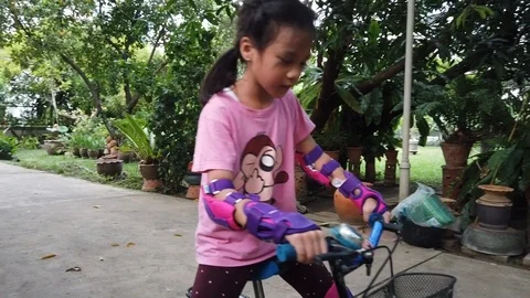 girl learning to ride a bike