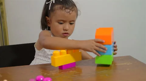 Little Girl Learning to Stack Blocks (HD) Stock Footage 4156414