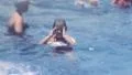 Little Girl Learning To Swim in Public Pool 1950s Vintage Film Home Movie 1kzv HD Footage